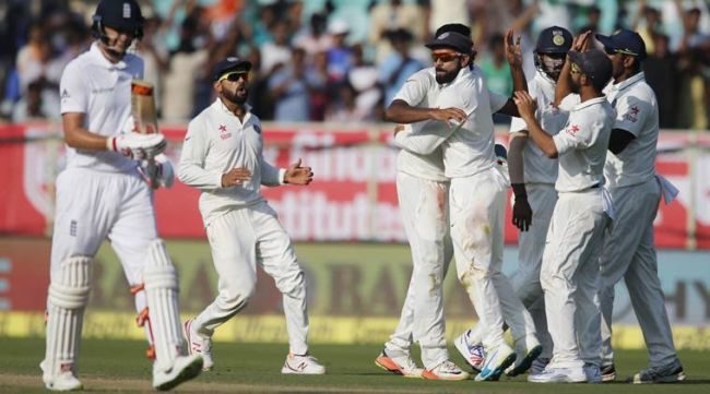 Indian players celebrate the dismissal of England's Joe Root, left, on the second day of their second cricket test match in Visakhapatnam, India, Friday, Nov. 18, 2016. (AP Photo/Aijaz Rahi)